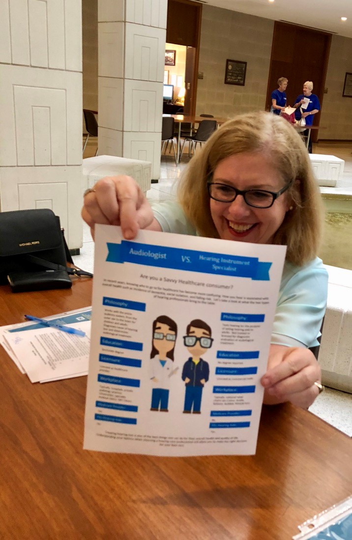  Dr. Sheri Mello displays a handout created by Dr. Melissa Karp explaining the difference between Audiologists and Hearing Aid Dispensers. 